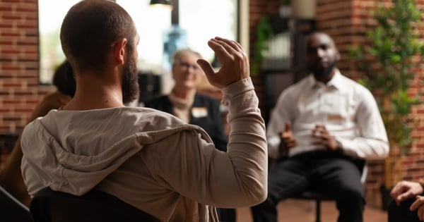 people in circle at rehab meeting